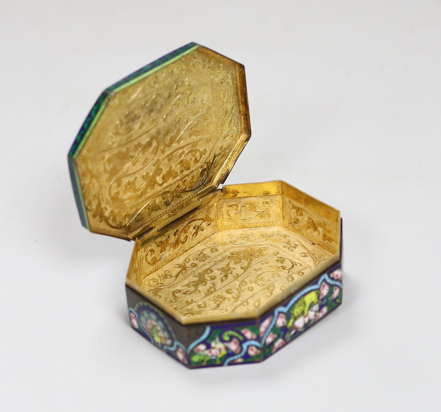 An early 20th century Indian gem set and enamelled gilt white metal trinket box, 10cm long